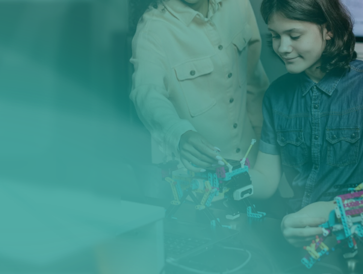 two girls working on robots