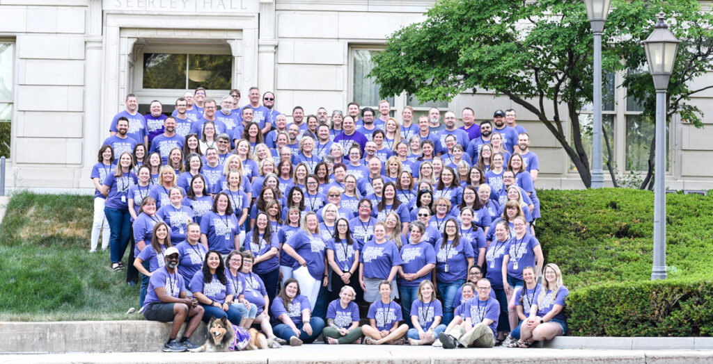 Large group picture of Iowa educators attending the 2023 CS PD Week wearing purple shirts that say "This is my teaching computer science shirt"